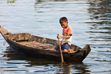 Boy paddling on Tonle Sap Lake